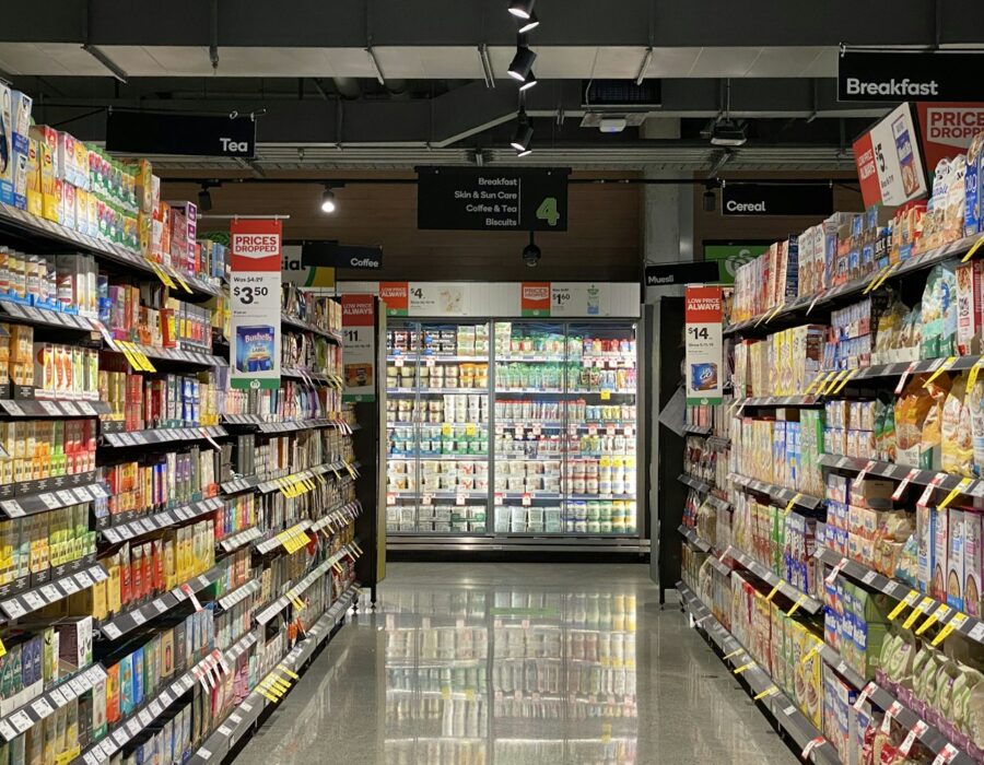 Supermarket aisle with packaged food products on shelves