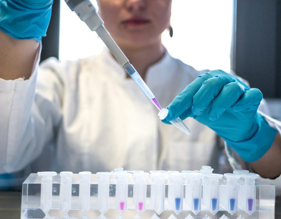 Scientist pipetting samples in a testing laboratory