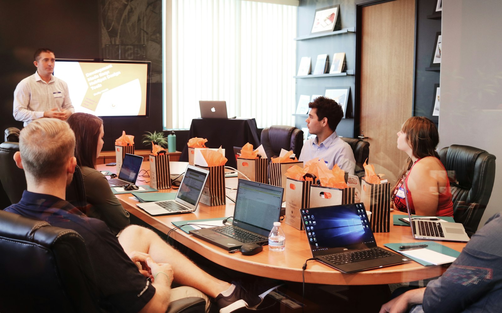 Consultant presenting to a startup team around a table